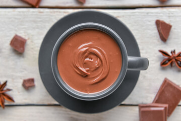 Composition with tasty melted chocolate on white wooden background