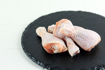 Fresh Raw Chicken Leg Drumstick on Slate Plate