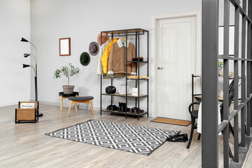 Interior of stylish hall with coat rack and door