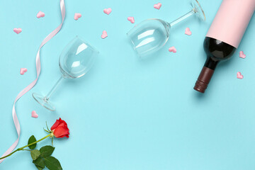 Composition with bottle of wine and rose flower for Valentine's day on blue background