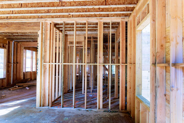 Work in progress view of construction unfinished house with wooden framing beams
