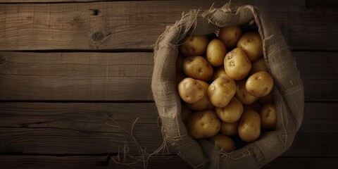 A top view of raw potato food, with fresh potatoes arranged in an old sack on a wooden background, wholesome essence of farm-to-table simplicity.