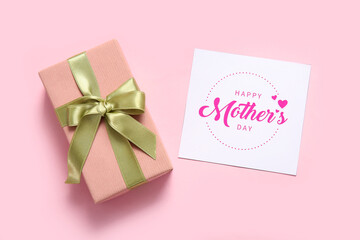 Card with text HAPPY MOTHER'S DAY and gift box on pink background