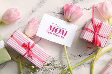 Card with text HAPPY MOTHER'S DAY, gift boxes and beautiful flowers on light background