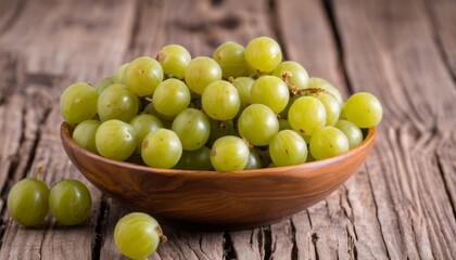 A wooden bowl filled with green grapes