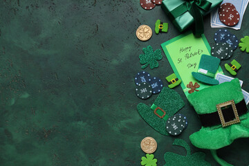 Fototapeta na wymiar Composition with poker chips, greeting card and decorations for St. Patrick's Day celebration on green grunge background