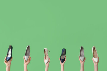 Women with stylish heels on green background