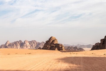 Fototapeta na wymiar The unforgettable beauty of vast expanse of endless sandy red desert of Wadi Rum near Amman in Jordan