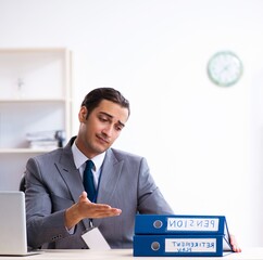 Young male accountant working in the office