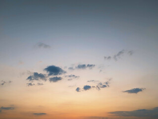 A serene view of the sky at sunset, characterized by soft, diffused lighting.