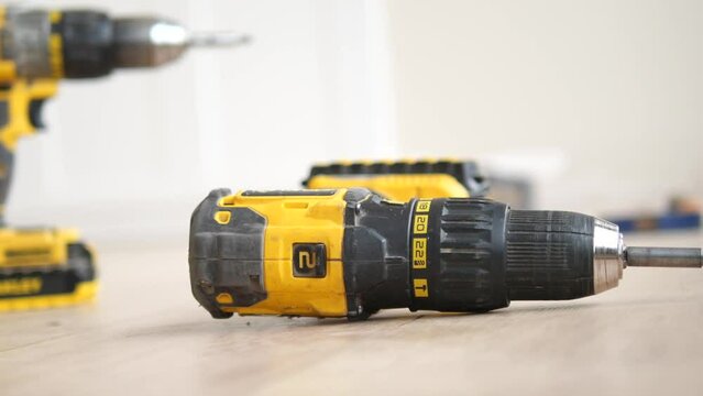 An electric screwdriver is on the floor, 
