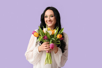 Beautiful young woman with bouquet of tulips on lilac background. International Women's Day