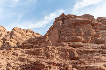 Fototapeta premium Bizarre shapes of the high mountains in the red desert of the Wadi Rum near Amman in Jordan
