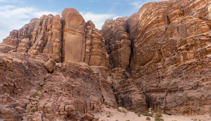 Fototapeta premium Bizarre shapes of high mountains in red desert of the Wadi Rum near Amman in Jordan
