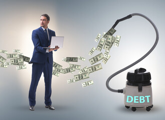 Businessman and vacuum cleaner sucking money out of him