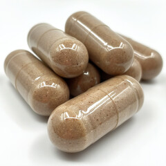Close-Up View of Tan Beige Capsules Stack on White Background
