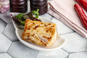 Roasted cod fish steak with salad
