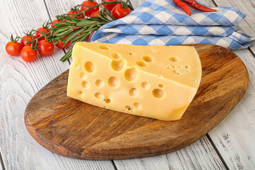 Maasdam cheese piece over board