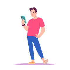 Young man in red T-shirt and sneakers standing and looks at his smartphone.
