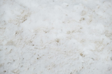 Abstract and textured white, not shiny and glittery snow background in sunlight. Winter scenery