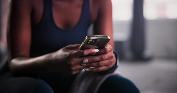 Woman, hands and phone in fitness for communication, social media or typing on sports app at gym. Closeup of female person or athlete on mobile smartphone for online chatting or texting on break
