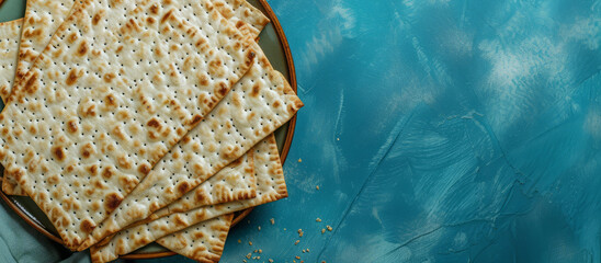 Jewish holiday Passover concept with matzah and copy space. Top view, flat lay. blue background.