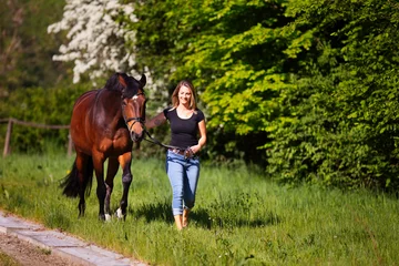 Foto op Canvas Young woman with horse in spring in nature. © RD-Fotografie