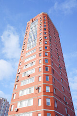 multi-storey residential buildings against a background of blue sky with clouds