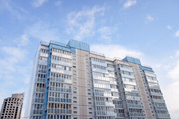 Fototapeta na wymiar multi-storey residential buildings against a background of blue sky with clouds