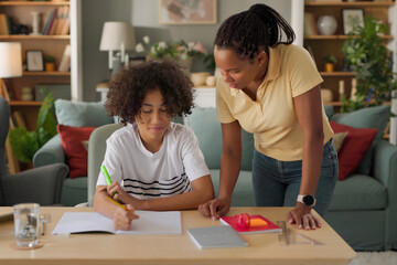 Mom helping a teenage son study for exam at home