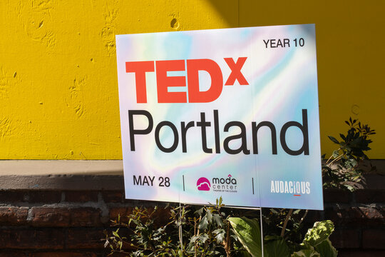 Portland, OR, USA - Apr 7, 2022: Ads for an upcoming TEDx event are seen at an office building in Portland, Oregon. TEDx stands for independently organized TED event celebrating locally-driven ideas.