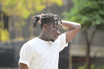 A young man with his hairstyle and the atmosphere of living in the community.