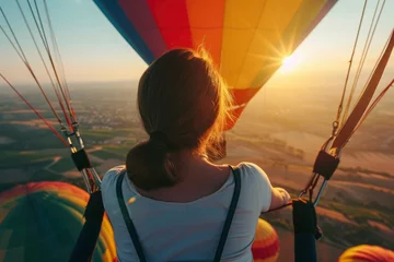 Foto op Plexiglas Rear view of a woman enjoying a beautiful hot air balloon ride. Ride a hot air balloon © Neda Asyasi
