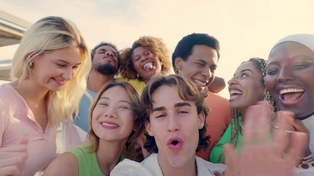Crazy group of multi-ethnic friends taking a happy selfie outdoors