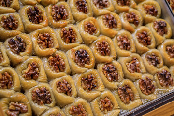Traditional Turkish dessert, walnut birds nest baklava or bulbul yuvasi whole nuts in fresh phyllo dough at a local pastry shop in Istanbul, Turkey