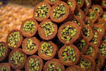 Traditional Turkish dessert, fresh crispy layered pistachio baklava or ballorieh in a cone at a local pastry shop in Istanbul, Turkey