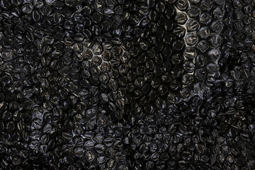 Texture, black bubble plastic wrap surface. plastic with air balls on the surface used to pack. Detail of plastic material..