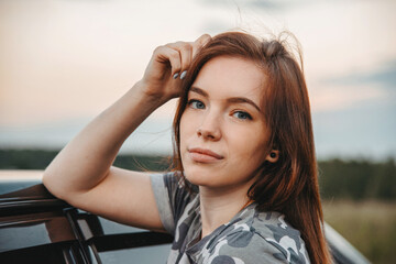 Fototapeta premium Close-up portrait of a cute girl. Cute young girl.Portrait of a girl at sunset