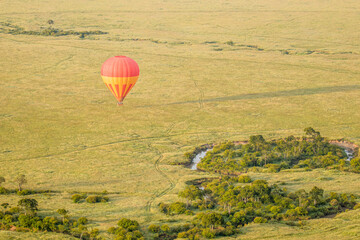 Obraz premium Colourful hot air balloon flying over Masai Mara National Reserve, Kenya.