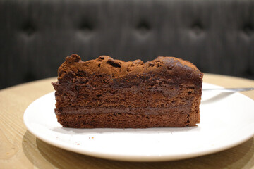 A Dark chocolate cake at white plate