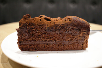 A Dark chocolate cake at white plate