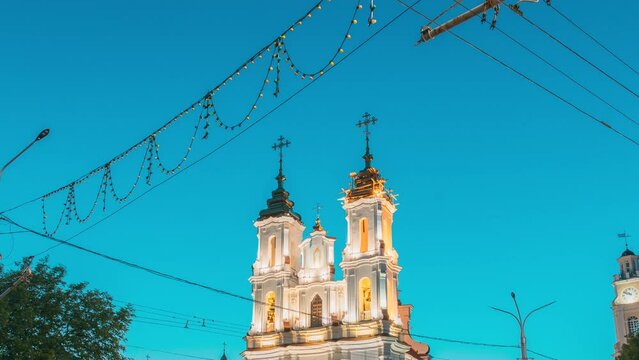 Vitebsk, Belarus. Famous Landmark. Travel Destinations. Hyperlapse View On Church Of Resurrection Of Christ On Market Square In Evening Or Night Illuminations. Traffic Car Lights Motion. Bold Colors.