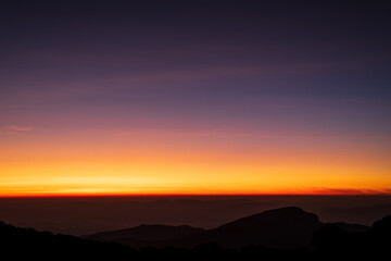 Beautiful skyline in sunrise over mountains.