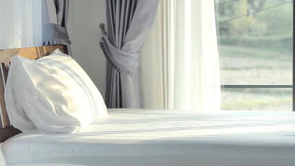 Pillows placed on a soft white mattress in the bedroom