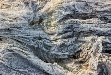 The texture of a crumpled plastic bag illuminated by sunlight during winter