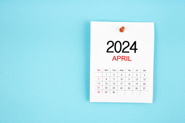 April 2024 calendar page with push pin on blue background.
