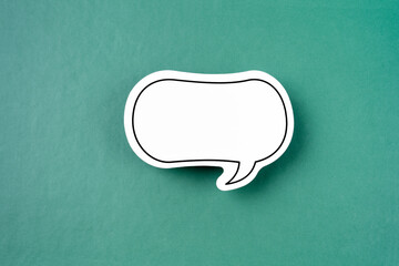 White empty speech bubble on green background.