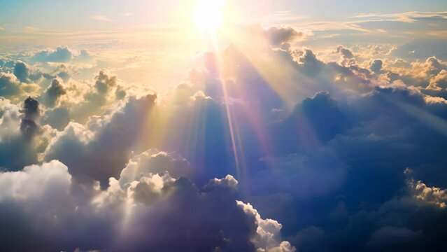 Strong sunshine piercing through the clouds with shining rays illuminating the sky
