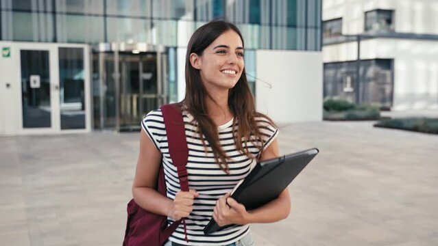 Young Hispanic University Student Woman walking after classes