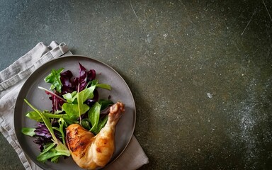 Wholesome mix of tender chicken leg and vibrant salad leaves